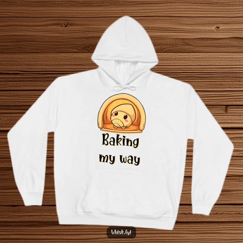 Funny croissant hoodie featuring a curious croissant character peeking into a warm oven, perfect for cozy evenings.