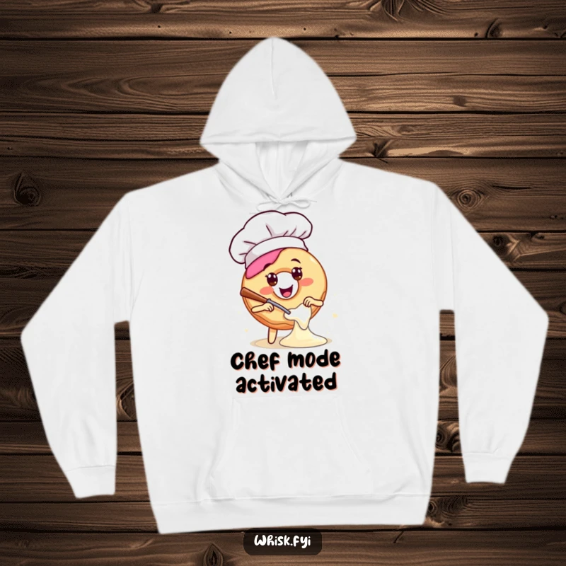 Funny hoodie featuring a happy donut in a chef hat, energetically mixing batter, perfect for cozy baking sessions with a humorous twist.