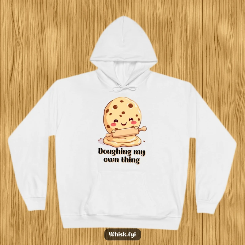 Funny hoodie depicting a cheerful cookie character expertly rolling dough with a small pin, perfect for cold days.